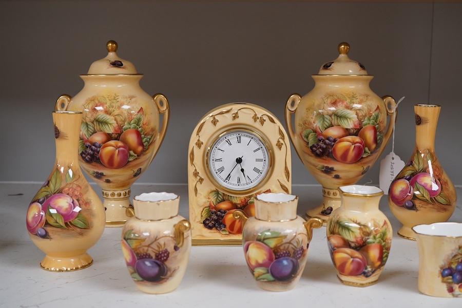 A collection of Aynsley Orchard Gold wares including a timepiece, vases, etc. tallest 23cm